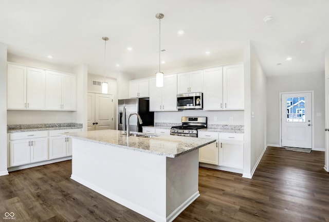 kitchen featuring white cabinetry, an island with sink, pendant lighting, and appliances with stainless steel finishes