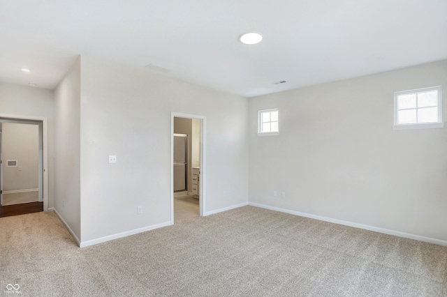 empty room featuring light colored carpet