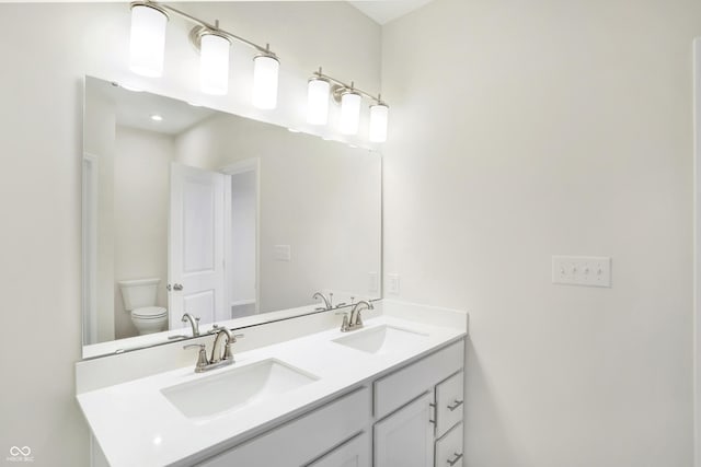 bathroom with vanity and toilet