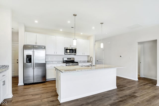 kitchen featuring sink, hanging light fixtures, a center island with sink, white cabinets, and appliances with stainless steel finishes