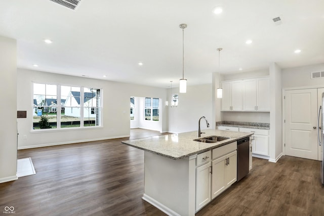 kitchen featuring dishwasher, sink, light stone counters, a center island with sink, and white cabinets