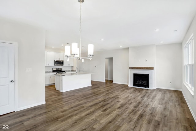 unfurnished living room with sink and dark wood-type flooring