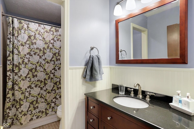 bathroom with tile patterned flooring, vanity, toilet, and a shower with curtain