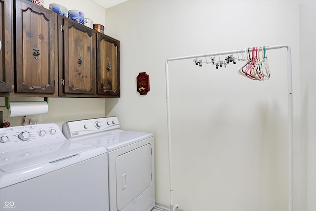 laundry area with washer and clothes dryer and cabinets