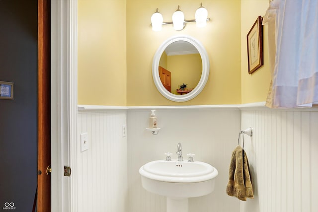 bathroom with crown molding and sink