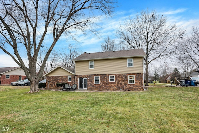 back of property with a patio and a lawn