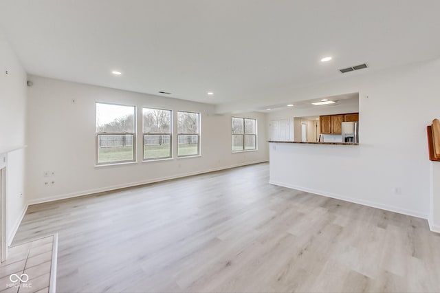 unfurnished living room with light wood-type flooring