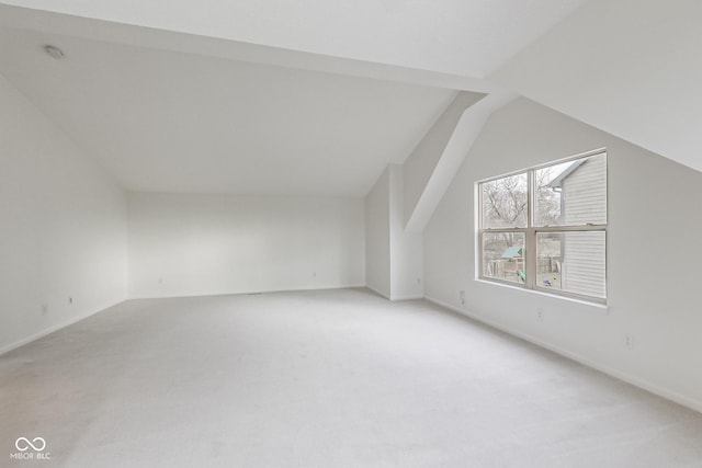 bonus room featuring lofted ceiling and carpet floors