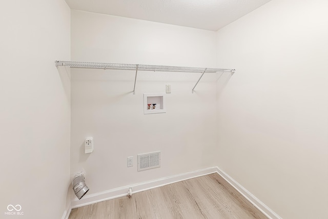 washroom featuring hookup for a washing machine and hardwood / wood-style floors