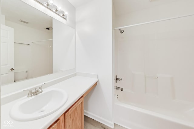 full bathroom with vanity, tub / shower combination, and toilet