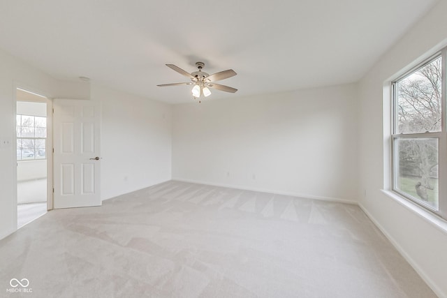 unfurnished room featuring light carpet and ceiling fan