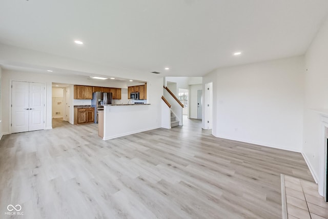 unfurnished living room with light hardwood / wood-style flooring