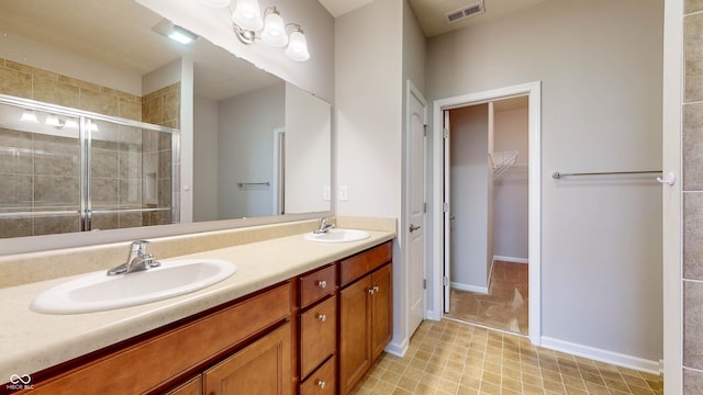 bathroom featuring vanity and a shower with door