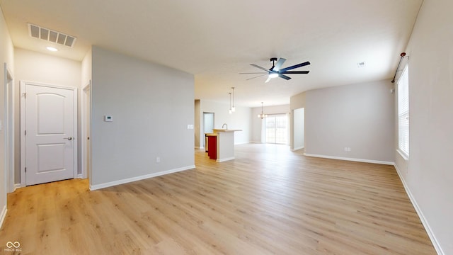 unfurnished living room featuring ceiling fan and light wood-type flooring