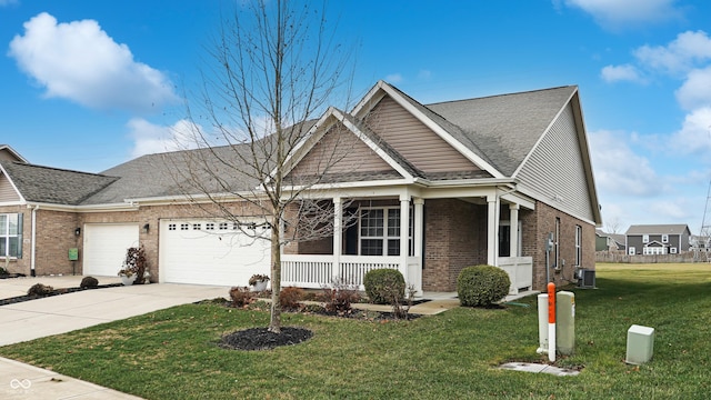 view of front of house with a front lawn, central AC unit, a porch, and a garage