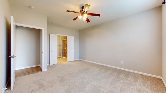 unfurnished bedroom featuring ceiling fan and light carpet