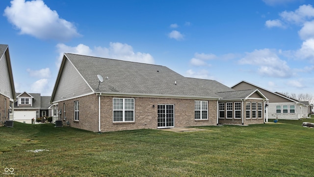 rear view of property with a yard