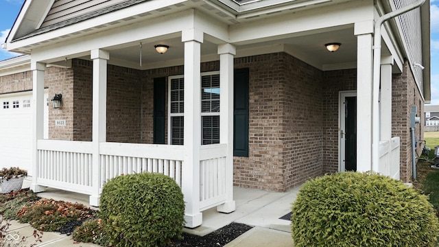 entrance to property with a porch and a garage