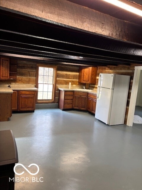 kitchen with white refrigerator and wooden walls