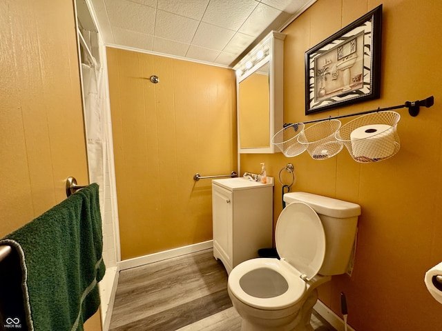 bathroom with a shower with curtain, crown molding, toilet, vanity, and hardwood / wood-style flooring