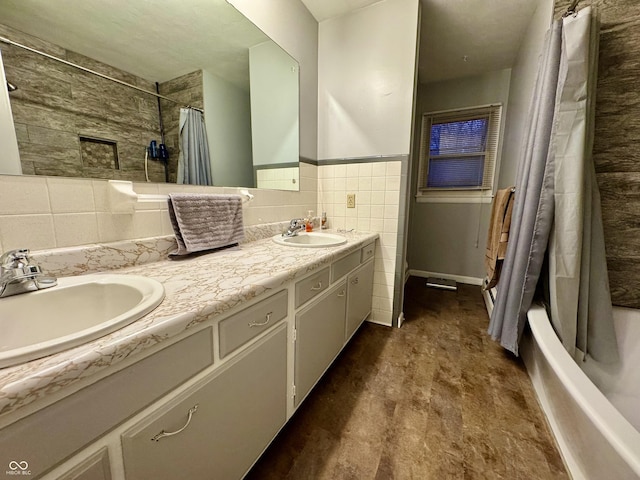 bathroom featuring vanity, shower / bathtub combination with curtain, and tile walls