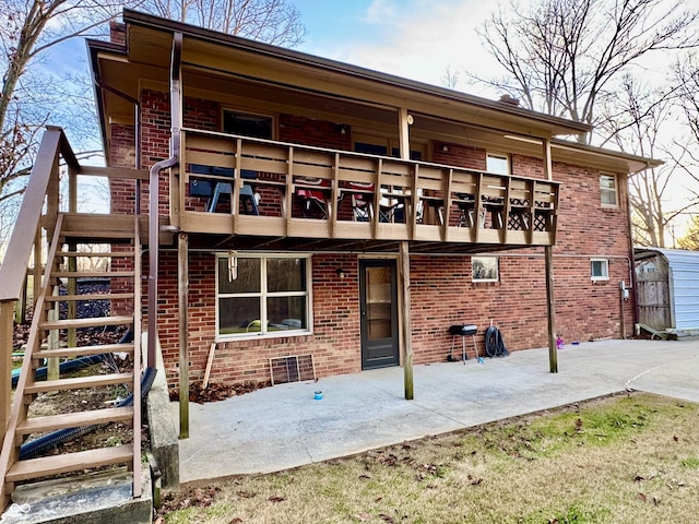 rear view of property with a patio area and a balcony