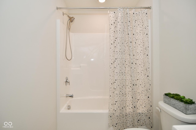 bathroom with toilet and shower / bath combo with shower curtain