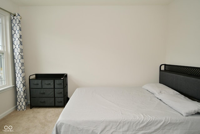 bedroom featuring light carpet