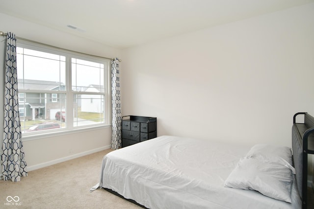 bedroom featuring light carpet