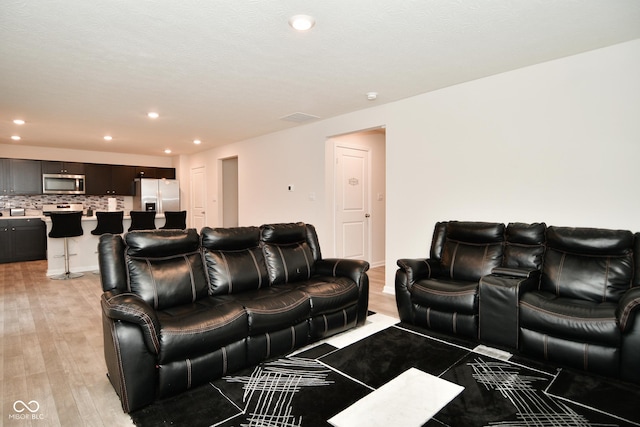 home theater with light hardwood / wood-style flooring