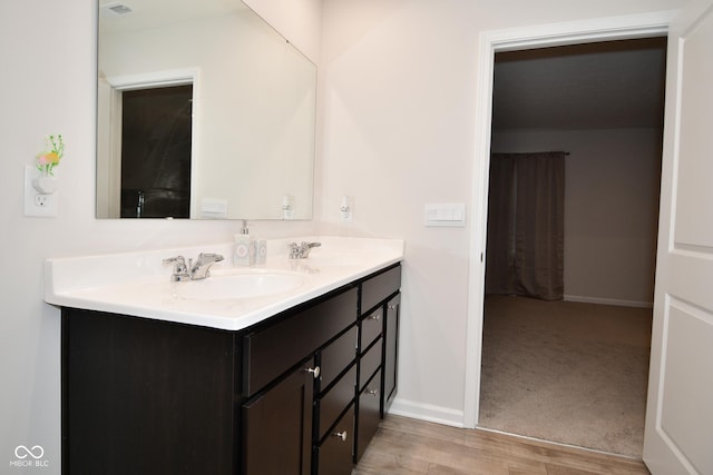 bathroom featuring vanity and wood-type flooring