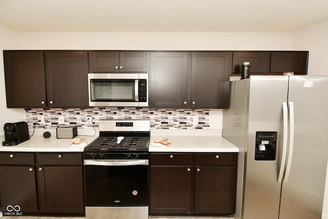 kitchen with dark brown cabinetry, stainless steel appliances, and tasteful backsplash