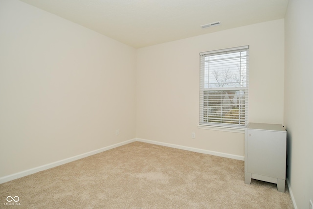 unfurnished room featuring light colored carpet