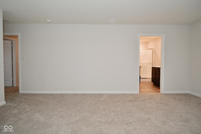 empty room featuring light colored carpet