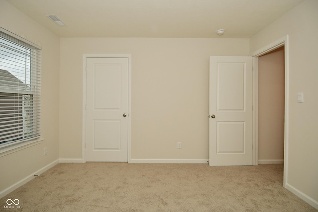 empty room with light colored carpet