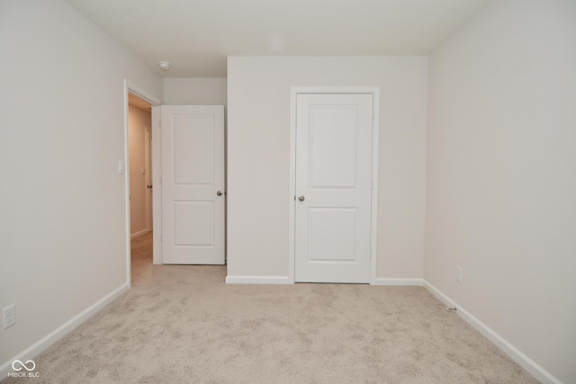 unfurnished bedroom featuring light colored carpet