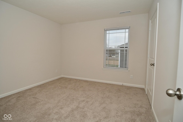 unfurnished room featuring light colored carpet