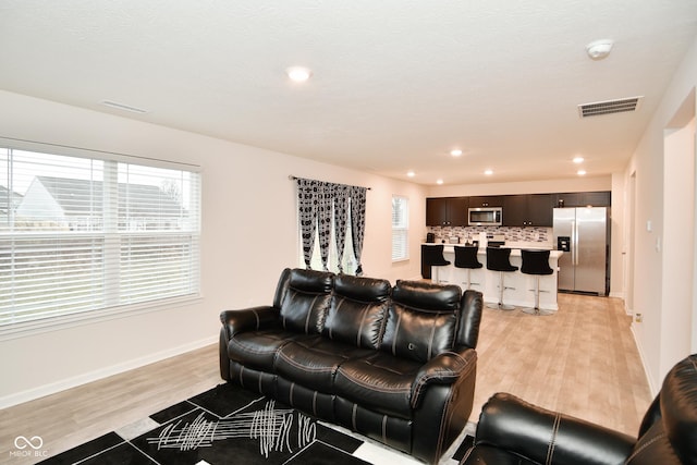 living room with light hardwood / wood-style flooring