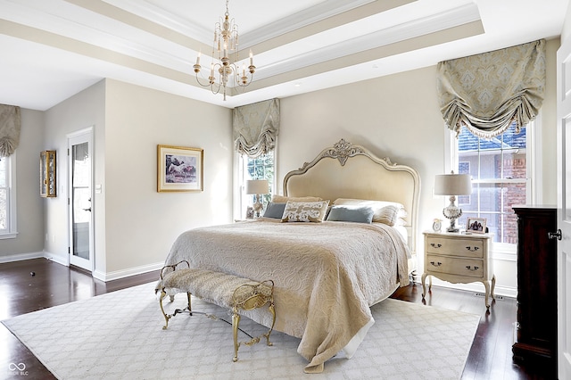 3441 S Overlook Pass, New Palestine, IN 46163 - bedroom featuring dark wood-style floors, multiple windows, a chandelier, a tray ceiling, and ornamental molding