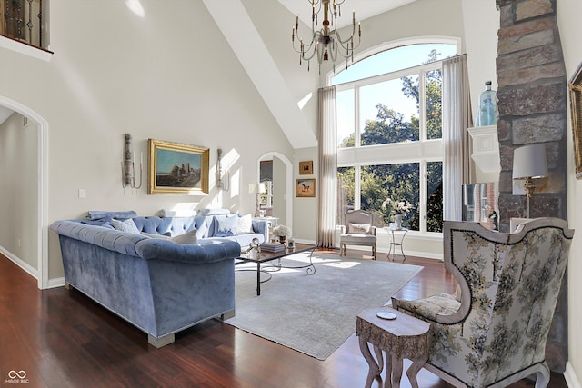 3441 S Overlook Pass, New Palestine, IN 46163 - living area featuring arched walkways, a towering ceiling, wood finished floors, healthy amount of natural light, and a chandelier
