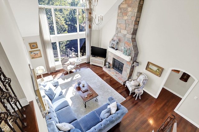 3441 S Overlook Pass, New Palestine, IN 46163 - living area with a high ceiling, wood finished floors, a chandelier, and a stone fireplace