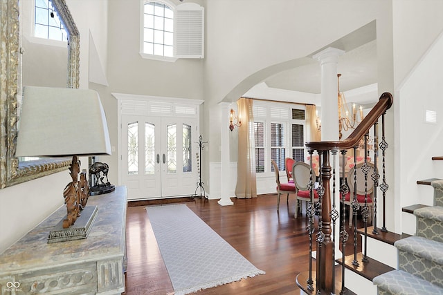 3441 S Overlook Pass, New Palestine, IN 46163 - entrance foyer featuring arched walkways, stairway, wood finished floors, healthy amount of natural light, and a towering ceiling