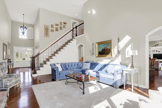 3441 S Overlook Pass, New Palestine, IN 46163 - living area with arched walkways, a towering ceiling, stairway, and dark wood-style floors