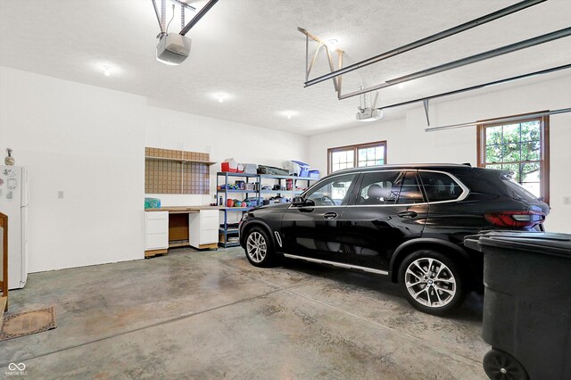 3441 S Overlook Pass, New Palestine, IN 46163 - garage with a garage door opener and freestanding refrigerator