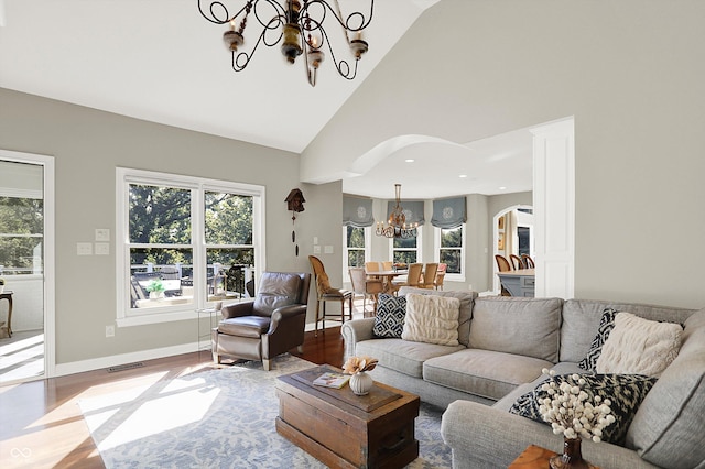 3441 S Overlook Pass, New Palestine, IN 46163 - living area with a chandelier, arched walkways, plenty of natural light, and high vaulted ceiling
