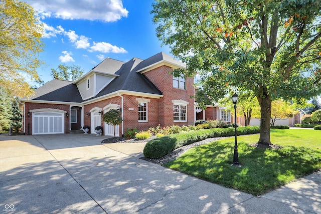 3441 S Overlook Pass, New Palestine, IN 46163 - view of front facade with brick siding, an attached garage, concrete driveway, a front yard, and a shingled roof