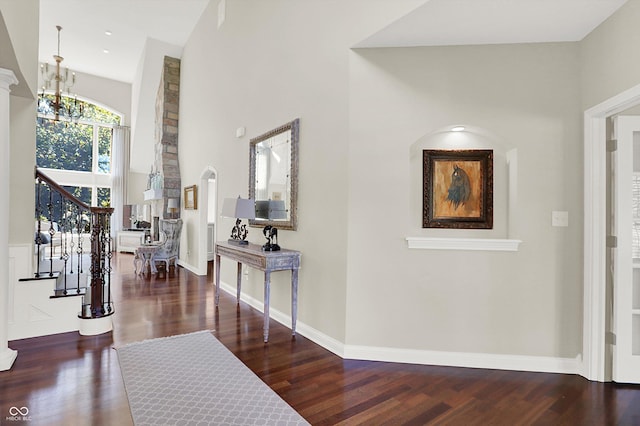3441 S Overlook Pass, New Palestine, IN 46163 - foyer entrance with a chandelier, wood finished floors, a towering ceiling, stairway, and arched walkways