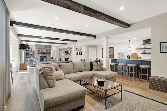 3441 S Overlook Pass, New Palestine, IN 46163 - living area featuring decorative columns, a fireplace, recessed lighting, light wood finished floors, and beam ceiling