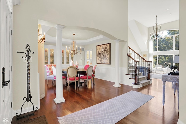 3441 S Overlook Pass, New Palestine, IN 46163 - dining area featuring a chandelier, wood finished floors, stairway, ornate columns, and a towering ceiling