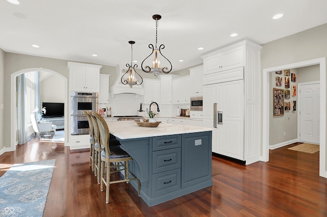3441 S Overlook Pass, New Palestine, IN 46163 - kitchen featuring built in appliances, white cabinetry, a center island with sink, dark wood finished floors, and recessed lighting